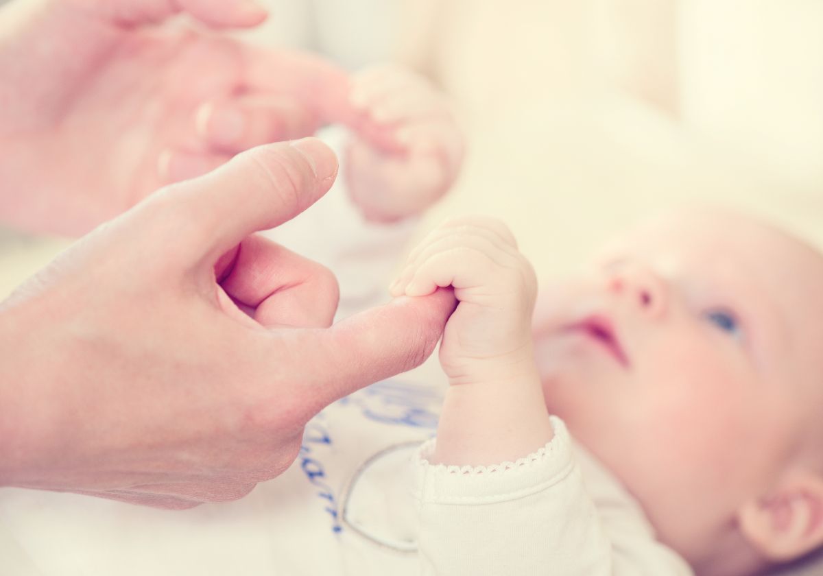 bigstock parent holding newborns hand 87709928
