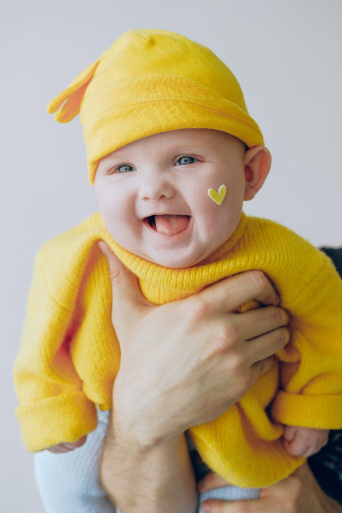 baby in yellow knit cap and yellow knit sweater 3845492